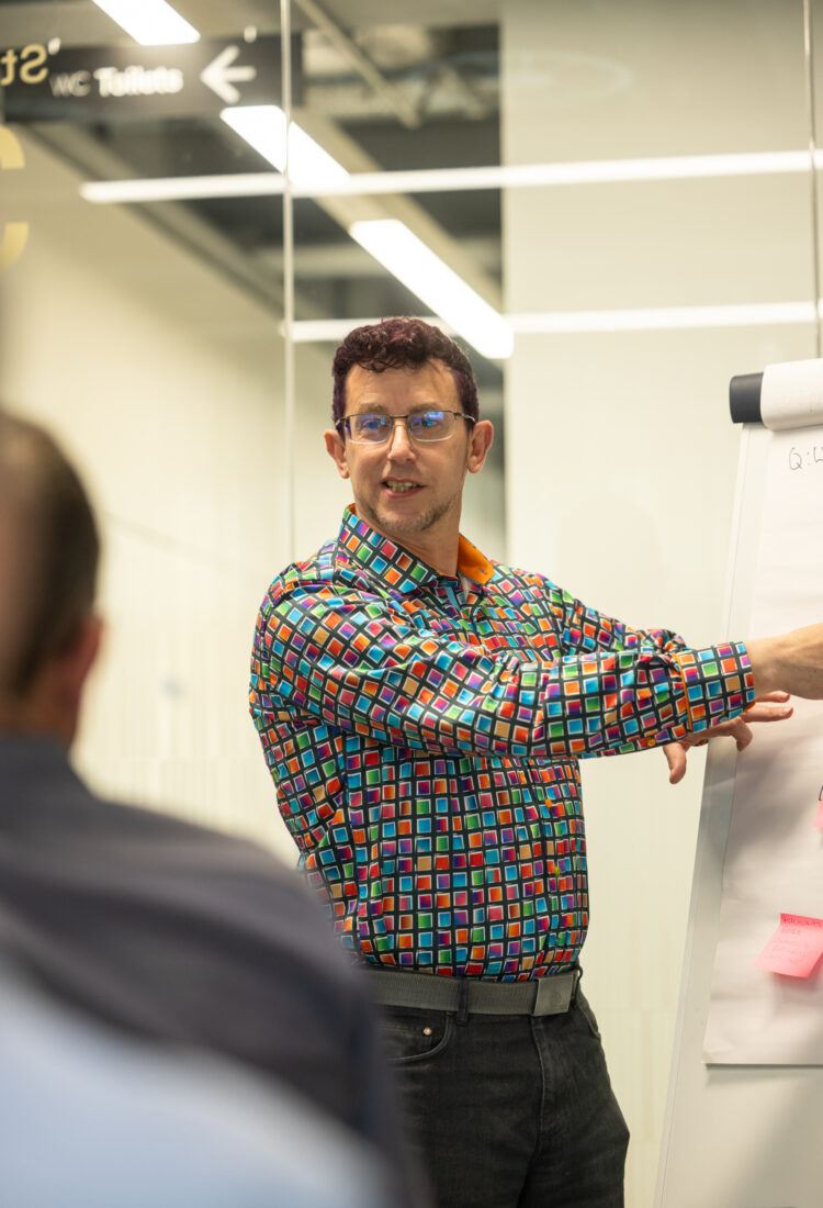 Wedge team member presenting ideas using a flipboard during a meeting. Wedge team member presenting ideas using a flipboard during a meeting.