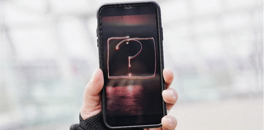 A held phone, with a question mark on the screen.