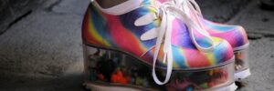 Rainbow coloured trainers with platform sole filled with toys.